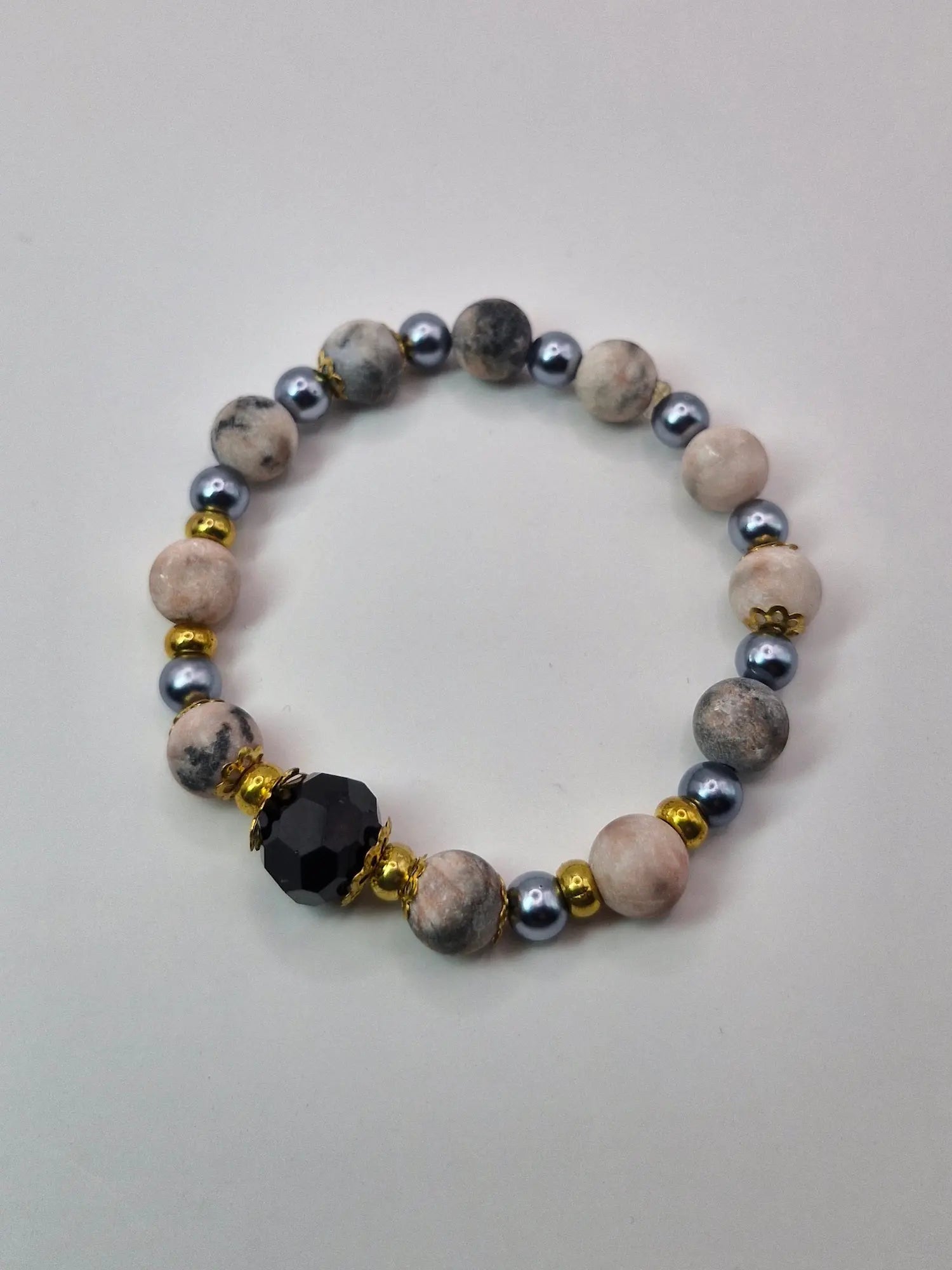 Bransoletka z czarną fasetowaną kulą i złotymi akcentami